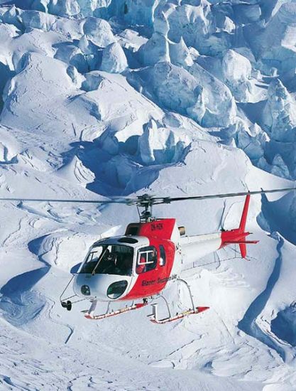 Helicopter flying above the Fox Glacier in the Southern Alps of the South Island of New Zealand