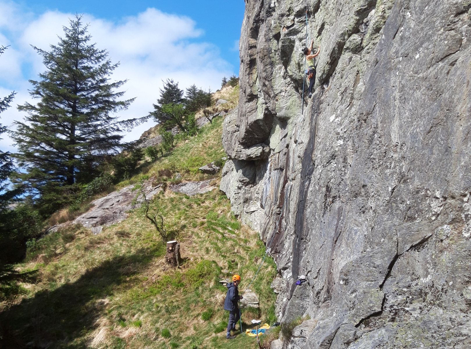 Climbers on rock wall beneath The Saddle